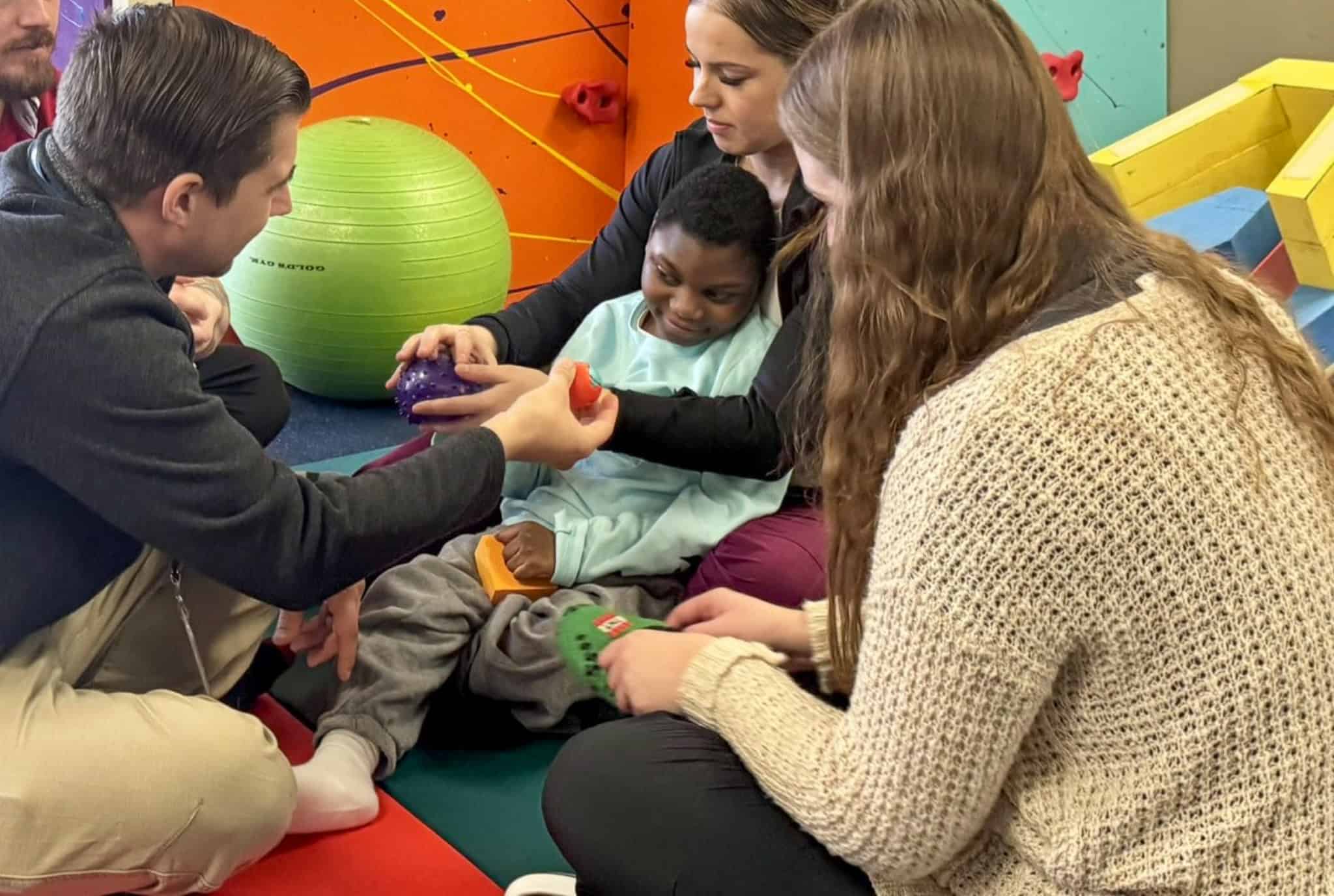 Physical therapist incorporating play into therapy at St. Mary’s Home